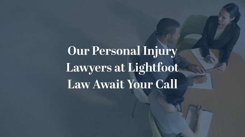 Our Washington DC personal injury lawyers at Lightfoot Law await your call - three lawyers sitting around a desk
